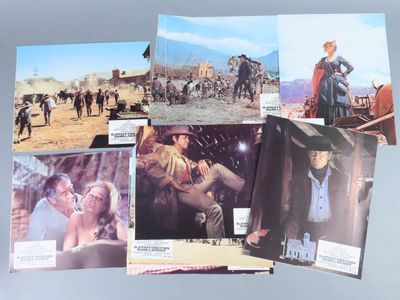 several old western movie posters are displayed on a table