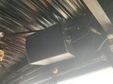a television mounted on the ceiling of a building