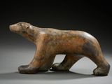 sculpture of a brown bear on a gray surface