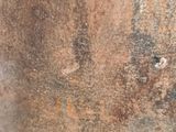 a close up of a rusted metal pot with a handle