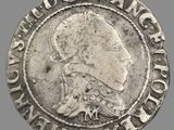 un gros plan d'une pièce d'argent sur laquelle figure l'effigie d'une femme