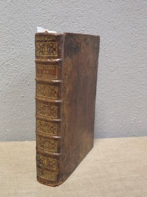 an old book sitting on top of a table next to a wall