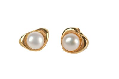 a pair of pearl earrings on a white background