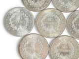 six different types of coins on a white surface