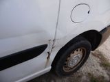 a white van with a hole in the side of it