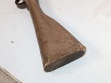 a wooden rifle that is laying on a table