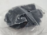 a plastic bag with a piece of black food in it