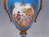 a blue vase with a picture of a man and a woman on it