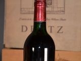 a bottle of wine sitting on a table next to a box of wine