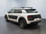 the back of a white car with a black roof rack on the back of it