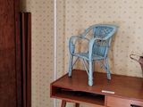 a blue chair sitting on top of a wooden desk