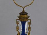 an image of a blue and gold vase lamp on a table
