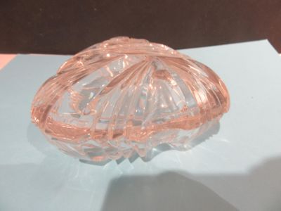 a glass bowl on a table with a blue surface
