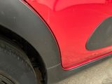 a close up of a red car with black rims