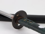 a close up of a samurai sword with a black handle