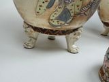 three vases that are sitting on a table