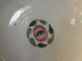 a white bowl with a pink flower on it