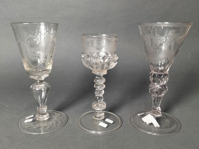 three glass goblets sitting next to each other on a table