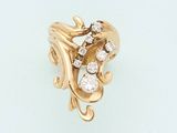 an image of a gold and diamond ring on a white surface