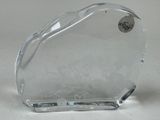 a glass heart shaped object on a white surface