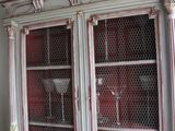 a white cabinet with a glass door and a bowl on top of it