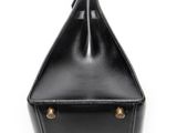 a black leather purse with gold hardware on the handle