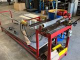 an industrial steel work bench in a large warehouse with lots of shelves
