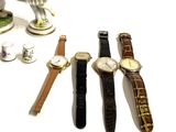 many different types of watches sitting on a table