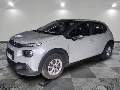 the white car is parked in the garage on a checkered floor