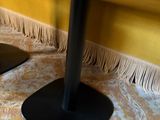 two black speakers on the floor next to each other
