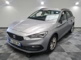 the grey car is parked on a checkered floor in a garage