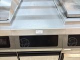 a kitchen with a stove, sink, and dishwasher