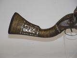a very old gun that is on display on the wall
