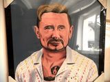 un tableau représentant un homme moustachu posé sur une étagère