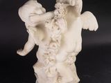 statue of an angel holding a child on a marble base