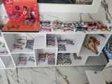 many glasses on the shelf and a picture on the wall