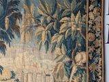 a tapestry hanging on the wall of a room
