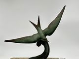 statue of a bird of paradise on a marble base