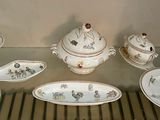 many plates and bowls on display in a glass case