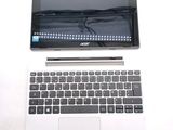 a laptop and a pen sitting next to each other on a table