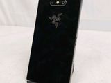 the back of a black phone with a dragon logo on it