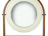 une horloge en bois surmontée d'un miroir circulaire