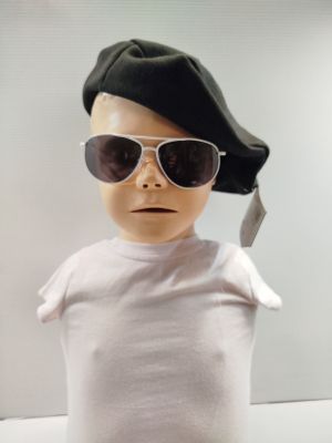 a baby wearing sunglasses and a hat with a cell phone in his mouth