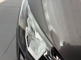 a close up of a car ' s headlight on a city street