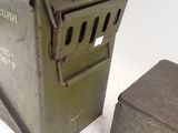 a small metal box and a small metal box on a white surface