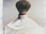 a poster of a man with a beard brush in his hair