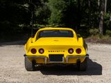 a yellow car that is parked in the dirt