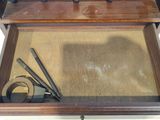 a small wooden box with tools inside of it