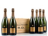 six bottles of champagne in front of a wooden box