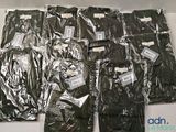several pairs of pants are wrapped in plastic bags on a table